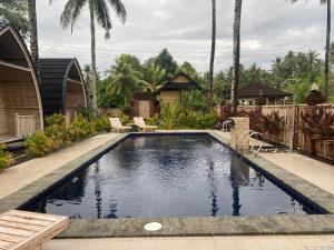 a swimming pool in the backyard of a house at Sari Lumbung Bungalow in Penginuman