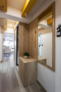 a kitchen with wood paneling and a mirror at Aparthotel Svitavy in Svitavy +128 photos