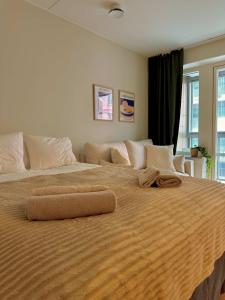 a large bed with two pillows on top of it at Modern studio with balcony in Stockholm
