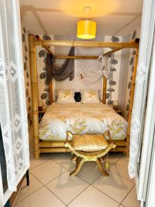 a bedroom with a bed with a wooden frame at La Petalerie Appartements d'hôtes in Épernay +81 photos