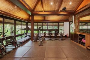 an indoor gym with treadmills and exercise bikes at Lihim Resorts in El Nido