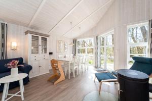 a living room with a blue couch and a table at Schmugglerstieg - Dorf Ferienhaus 03 in Priwall
