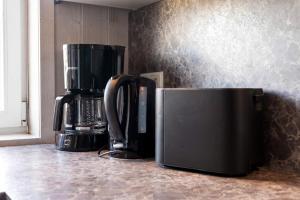 a microwave and a coffee maker on a counter at Schmugglerstieg - Dorf Ferienhaus 03 in Priwall