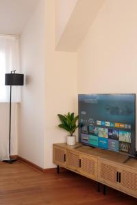 a living room with a large flat screen tv at Das Nomadenhaus - Garten, Grill, Nähe Köln in Bergheim