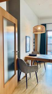 a dining room with a table and a chair at FeWo Alpenglühen in Gmund am Tegernsee +8 photos