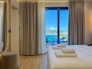 a bedroom with a bed with a view of the ocean at Erdeti Boutique Hotel in Sarandë +146 photos