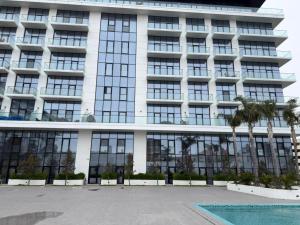 a large building with a pool in front of it at Sea Breeze Lighthouse in Nardaran