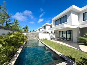 a swimming pool in the backyard of a villa at North Island View Family Duplex with private pool by LOV Mauritius in Grande Gaube