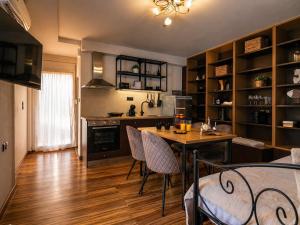 a kitchen with a table and chairs in a room at Cocomelo apts 3 luxury in Heraklio