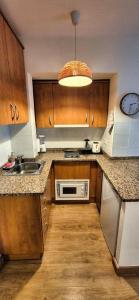 a kitchen with a sink and a microwave at Les Flors !2minutos de la playa! in Lloret de Mar +30 photos