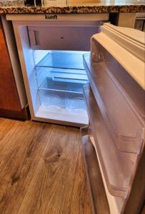 an empty refrigerator with its door open in a kitchen at Les Flors !2minutos de la playa! in Lloret de Mar