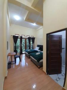 a bedroom with a bed and a table in a room at The Sanduk Inn in Rantepao
