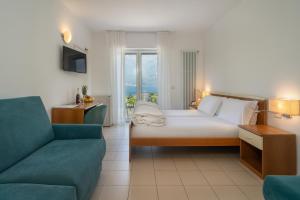 a hotel room with a bed and a couch at Hotel Casa Piantoni in Limone sul Garda +66 photos