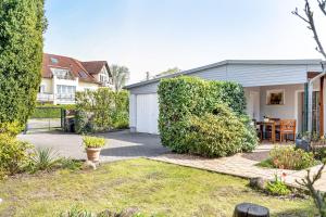 a garden with a house with a white garage at Ferienwohnung Auszeit in Berlin