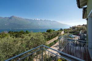 a balcony with a view of a lake and mountains at Hotel Casa Piantoni in Limone sul Garda