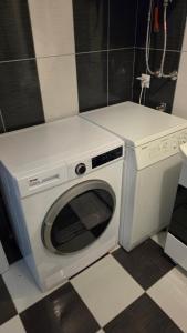 a white washer and dryer in a bathroom at Struga Alpha House in Struga