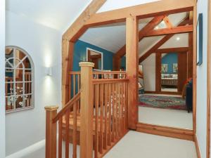 a wooden staircase in a house with a wooden door at Pylemoor Cottage in Tiverton