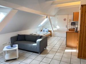 a living room with a couch and a table at Buschhaus Whg 1 in Krummhörn