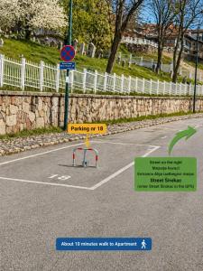 a street sign in a parking lot next to a fence at EPICENTAR Luxury Jacuzzi & Sauna Apartment in Baščaršija - Private Spa Experience in Sarajevo
