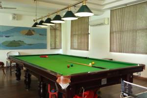 a billiard table in a room with afits at Orient Resorts in Kānpur
