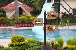 a resort with a water slide in the background at Orient Resorts in Kānpur