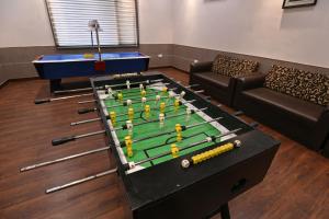 a living room with a pool table and a couch at Orient Resorts in Kānpur +6 photos