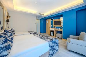 a bedroom with blue walls and a bed and a couch at Downtown Sirkeci Hotel in Istanbul +75 photos