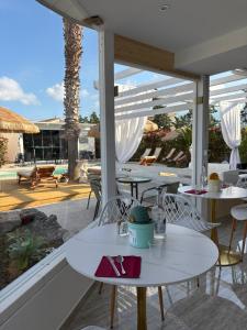 a patio with tables and chairs and a pool at B&B Resort El Bisagrà in Scalea