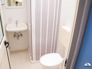 a bathroom with a toilet and a sink at Le Fontanelle 2 in Fontanelle