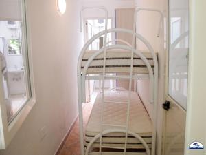 a spiral staircase in a room with a window at Le Fontanelle 2 in Fontanelle