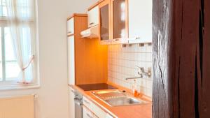 a small kitchen with a sink and a window at Hotel zur Post in Bacharach +46 photos