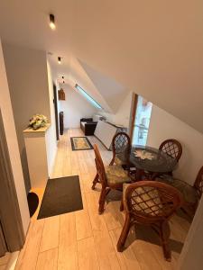 a room with a table and chairs and a living room at VillaVino in Szekszárd
