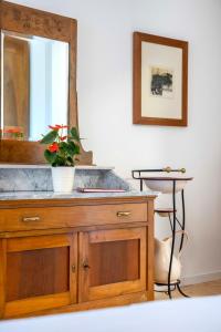 a wooden dresser with a mirror and a plant on it at NEW OPENING 2026 - Là di Maur - Appartamenti in Attimis