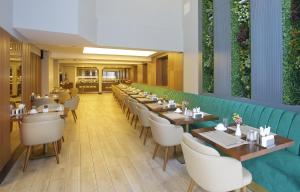 a restaurant with long tables and white chairs at Downtown Sirkeci Hotel in Istanbul