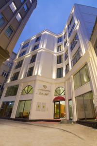 a large white building with a red umbrella at Downtown Sirkeci Hotel in Istanbul