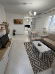 a living room with a couch and a table at Villa Kokoneshi in Divjakë