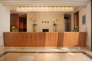 a lobby with a reception desk in a building at UNA Hotels Decò Roma in Rome