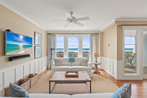 a living room with a couch and a tv at A112 Stella Aurea on 30A in Santa Rosa Beach