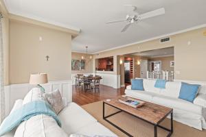 a living room with a white couch and a table at A112 Stella Aurea on 30A in Santa Rosa Beach