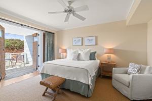 a bedroom with a bed and a chair and a window at A112 Stella Aurea on 30A in Santa Rosa Beach +42 photos