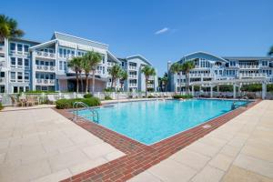a swimming pool in front of some apartment buildings at A112 Stella Aurea on 30A in Santa Rosa Beach