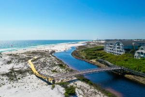 a bridge over a river next to a beach at A112 Stella Aurea on 30A in Santa Rosa Beach