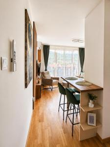 a kitchen and living room with a table and chairs at Panorama Gold in Soko Banja