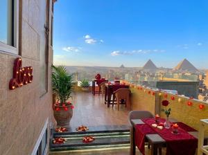 a view of the pyramids from the balcony of a restaurant at Horus Pyramids Horizon INN in Cairo