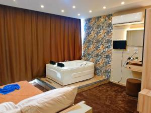 a bedroom with a bath tub in the corner of a room at Horus Pyramids Horizon INN in Cairo