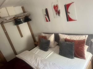 a room with a bed with pillows on it at Lahn-Paradies in Aull +39 photos
