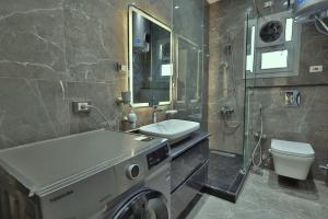 a bathroom with a sink and a toilet and a mirror at A very, very special residential unit in Madinaty +16 photos