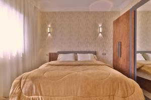 a bedroom with a large bed and a window at A very, very special residential unit in Madinaty