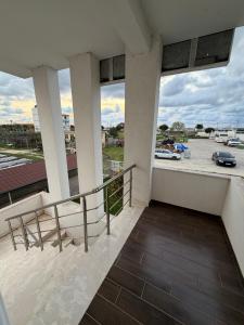 a balcony with a view of a parking lot at Villa Kokoneshi in Divjakë