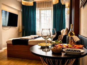 a hotel room with a table with food and wine glasses at Luka Suit Hotel in Istanbul